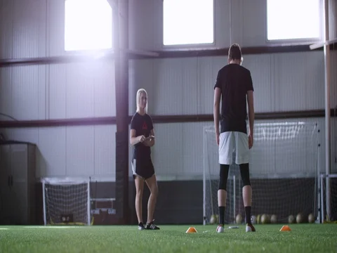 Athlete practicing long jump while trainer monitoring in sports ground 動画素材 77333096