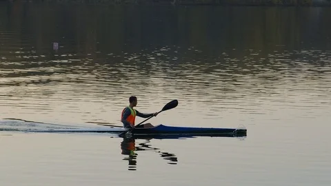 Athlete practicing rowing in a canoe or kayak Stock Footage 118614822