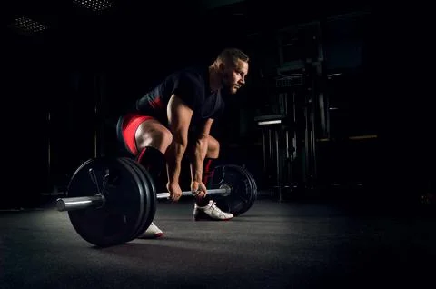 Athlete is prepared to perform an exercise called deadlift Stock Photos