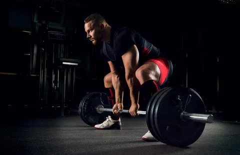 Athlete is prepared to perform an exercise called deadlift Stock Photos