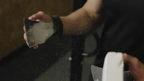Athlete prepares with chalk for climbing performance at indoor gym Stock Footage 327078479