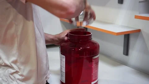 An athlete prepares a mixture of protein close up Stock Footage 132172896
