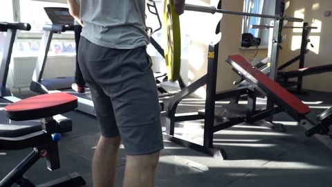 The athlete prepares the simulator in the gym Stock Footage 85954507