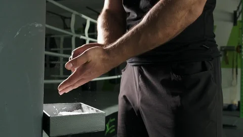 Athlete is preparing, hands claps after magnesia in fitness center. Super slow Video stock 118215526