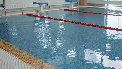 The athlete is preparing to jump into the pool and jumps Stock Footage 125573056