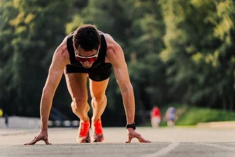 Athlete preparing to start in running position with copy space Stock Photos