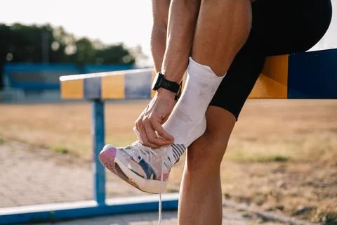 Athlete preparing for track running training on sunny day Stock Photos