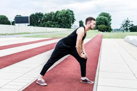 Athlete preparing for training on running track Stock Photos
