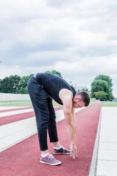 Athlete preparing for training on running track Stock Photos