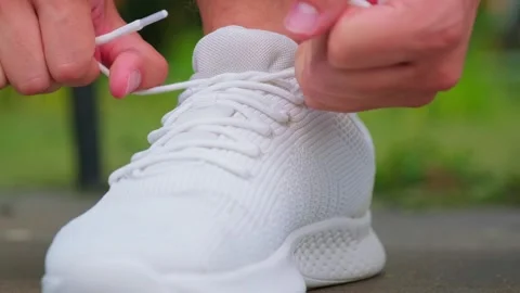 Athlete preparing for a workout session. Tying shoe laces. Morning routine... Stock Footage 339861255