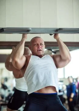 The athlete is pulled up on the horizontal bar Stock Photos