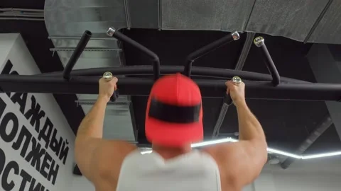 Athlete pulls himself up on the crossbar in the gym. Sports training, healthy Video stock 189951048