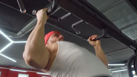 Athlete pulls himself up on the crossbar in the gym. Sports training, healthy Video stock 189952330