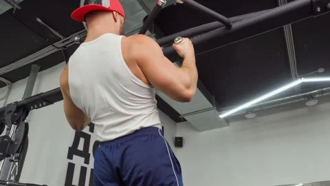 Athlete pulls himself up on the crossbar in the gym. Sports training, healthy Video stock 189952481