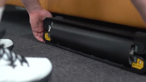 Athlete pulls portable treadmill out from under seat Stock Footage 180711197