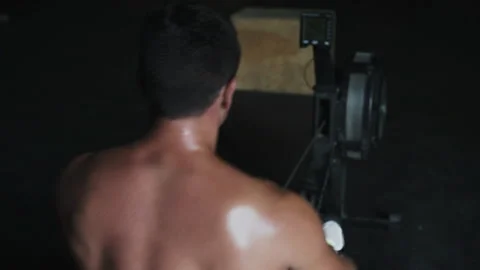 Athlete pulls weights from gym machine during intense workout session Stock Footage 312716669