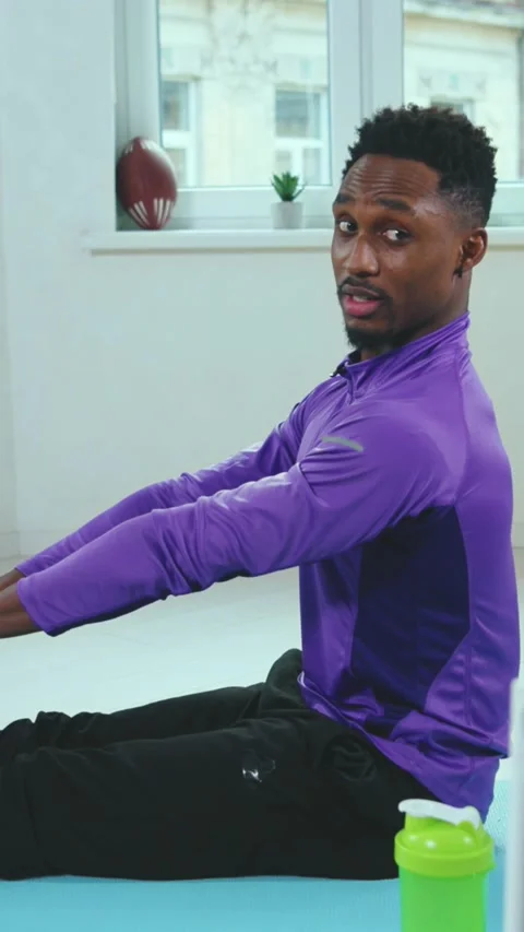An athlete in a purple top is energetically engaging in indoor fitness Vídeo Stock 316522722