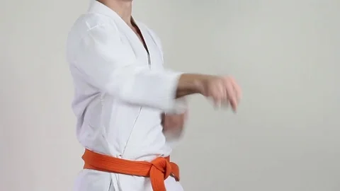 Athlete with a red belt on a light background makes the punch 動画素材 70173972