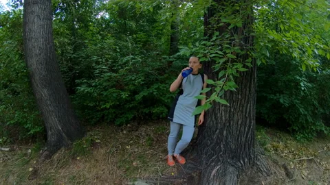 Athlete resting and drinking water in the woods Stock Footage 101511069
