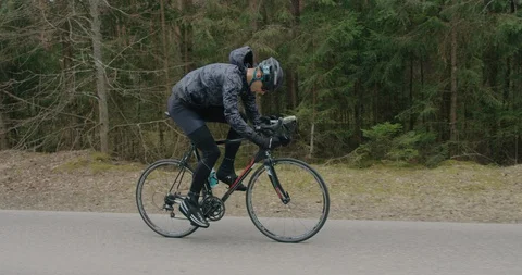 Athlete rides a bicycle through the woods Stock Footage 129018200