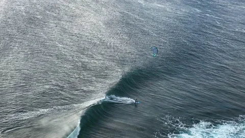 An athlete rides a kite on big waves in the Indian Ocean on the island of Stock Footage 221638161
