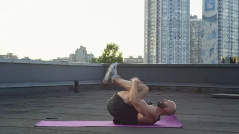The athlete rolls on his back on the mat with a nice view. Stock Footage 246492426