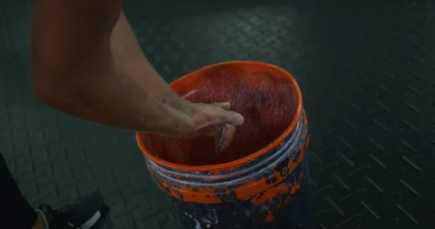 Athlete rubbing hands with chalk before a workout Stock Footage 96956708