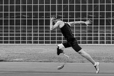 Athlete runner disabled running on track black and white photo Stock Photos