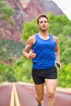 Athlete runner running on road Stock Photos
