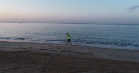 Athlete running on the beach Stock Footage 101098131