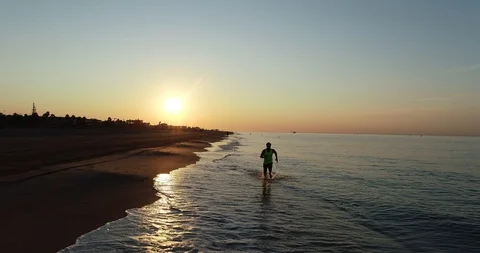 Athlete running on the beach Stock Footage 101098241