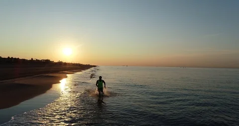 Athlete running on the beach Stock Footage 101098283