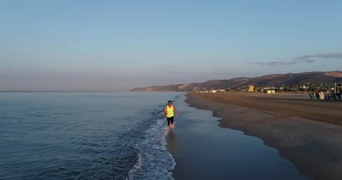 Athlete running on the beach Stock Footage 101098287