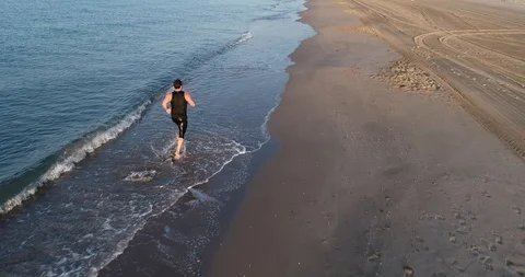Athlete running on the beach Stock Footage 101098482