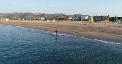 Athlete running on the beach Stock Footage 101098588