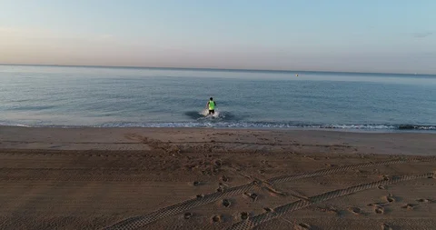 Athlete running on the beach Stock Footage 101098778
