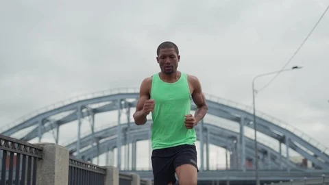 Athlete running down urban bridge Stock Footage 117064483