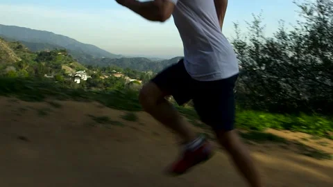 Athlete running up a hill Video stock 325989277