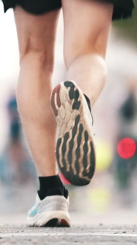 Athlete running in marathon, rear view of legs and feet Stock Footage 327639308