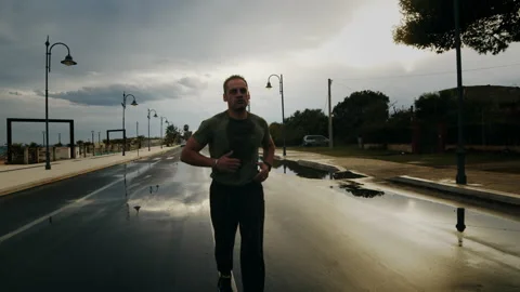 Athlete Running In The Rain Stock Footage 219484570