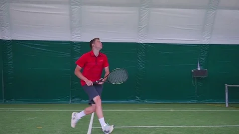 The athlete runs and jumps on the tennis court Stock Footage