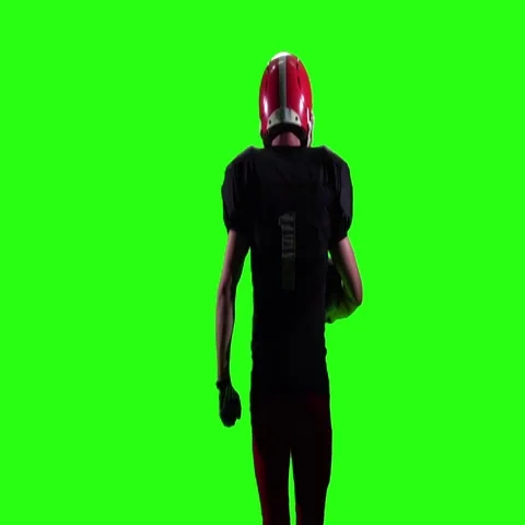 Athlete runs in a red helmet and protective gear with the ball in his hands Stock Footage