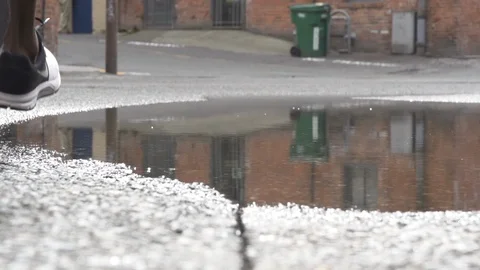 Athlete runs through puddle 1 Stock Footage 86882599