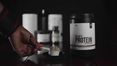 Athlete scooping nutritional meal replacement from a jar 動画素材 330189534