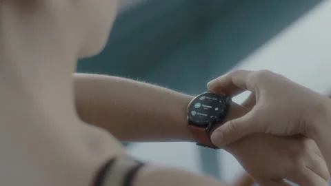 Athlete sets clock for exercise Stock Footage 146177301