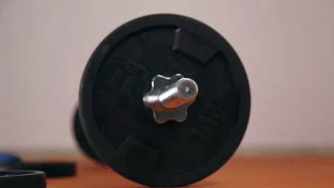 Athlete sets the weights on athletic rod Stock Footage 70563546