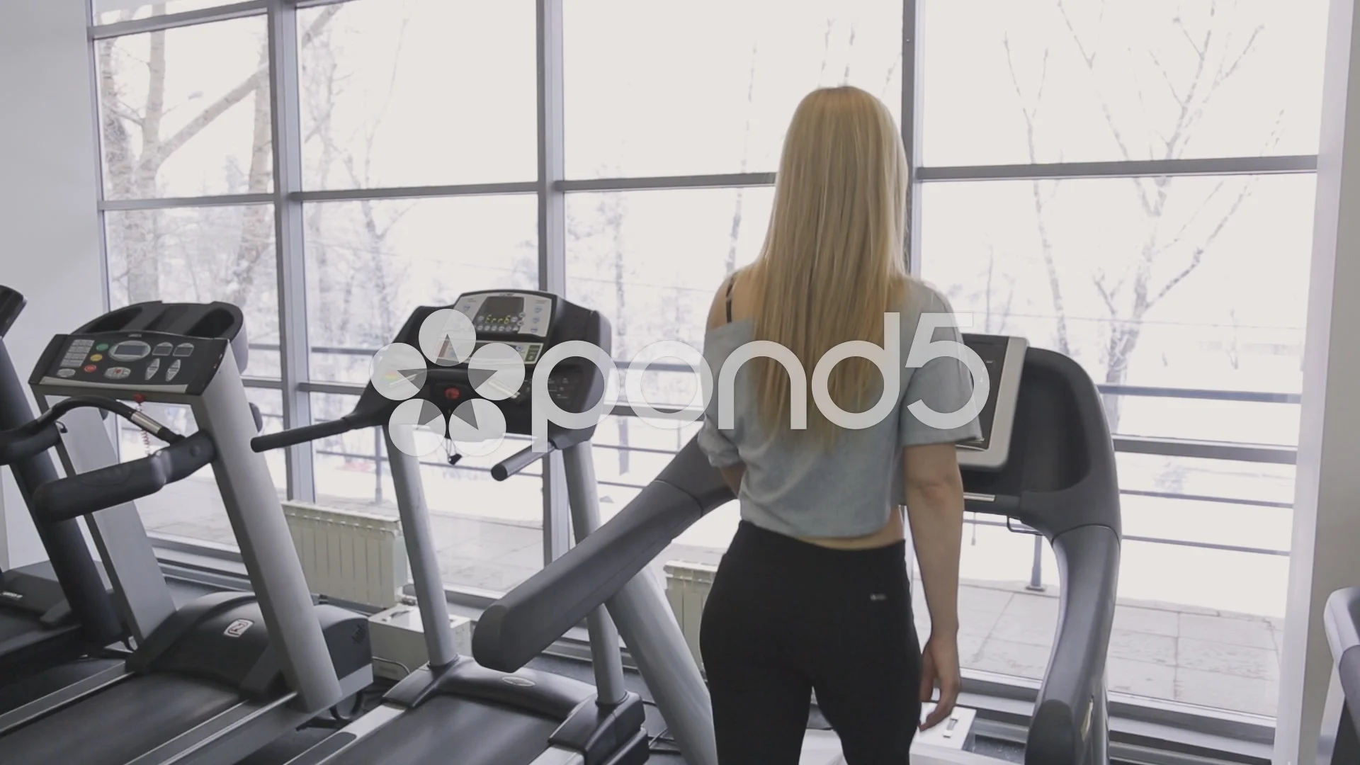 athlete sexy woman walking on a treadmill in the gym in front of panoramic