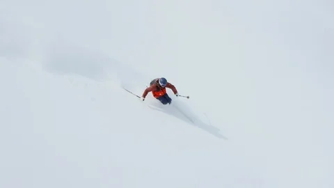 Athlete skiing through the snow covered mountain slopes during winter Stock Footage 116785838