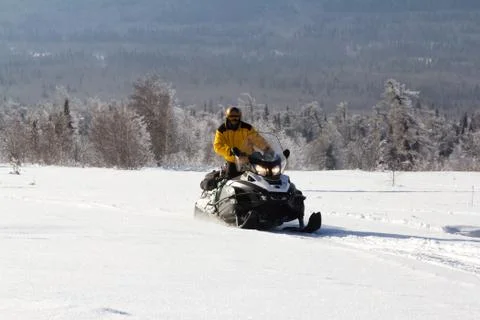 Athlete on a snowmobile Stock Photos