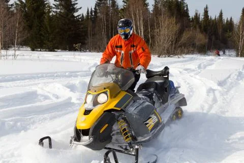 Athlete on a snowmobile. Stock Photos